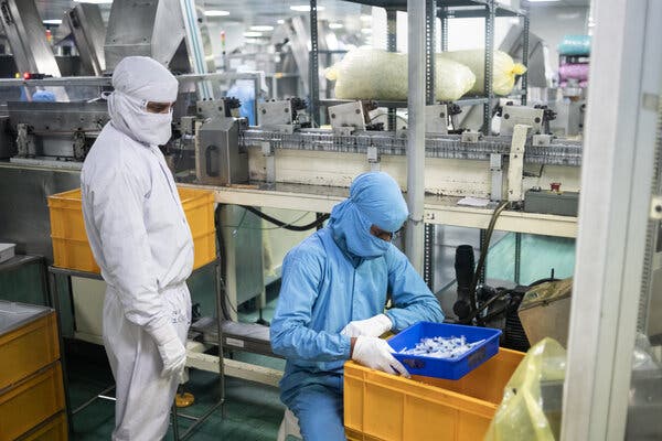 Workers checking syringes at Hindustan Syringes and Medical Devices, one of the world’s largest syringe makers.